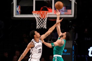 Jayson Tatum, who scored a game-high 41 points, shoots a layup over Nic Claxton during the Nets' 118-110 loss to the Celtics. 