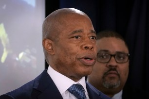 Mayor Eric Adams and Manhattan District Attorney Alvin Bragg stand at a press conference.