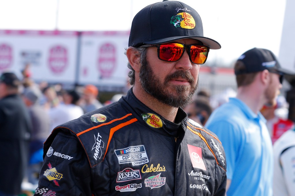 Martin Truex Jr., driver of the #19 Bass Pro Shops Toyota, walks the grid prior to the NASCAR Cup Series Ambetter Health 400.