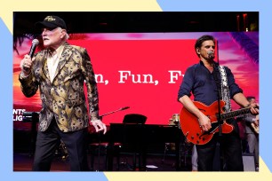 Beach Boys frontman Mike Love (L) and John Stamos rock out in concert.