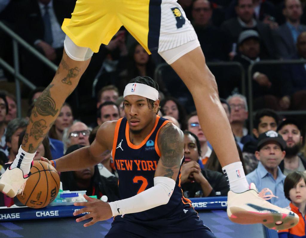 Miles McBride, who scored 16 points off the bench, drives past a leaping Obi Toppin during the Knicks' win.