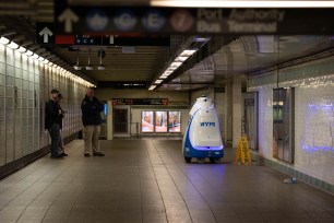NYPD patrol robot with police officers in Times Square subway station, in Manhattan.