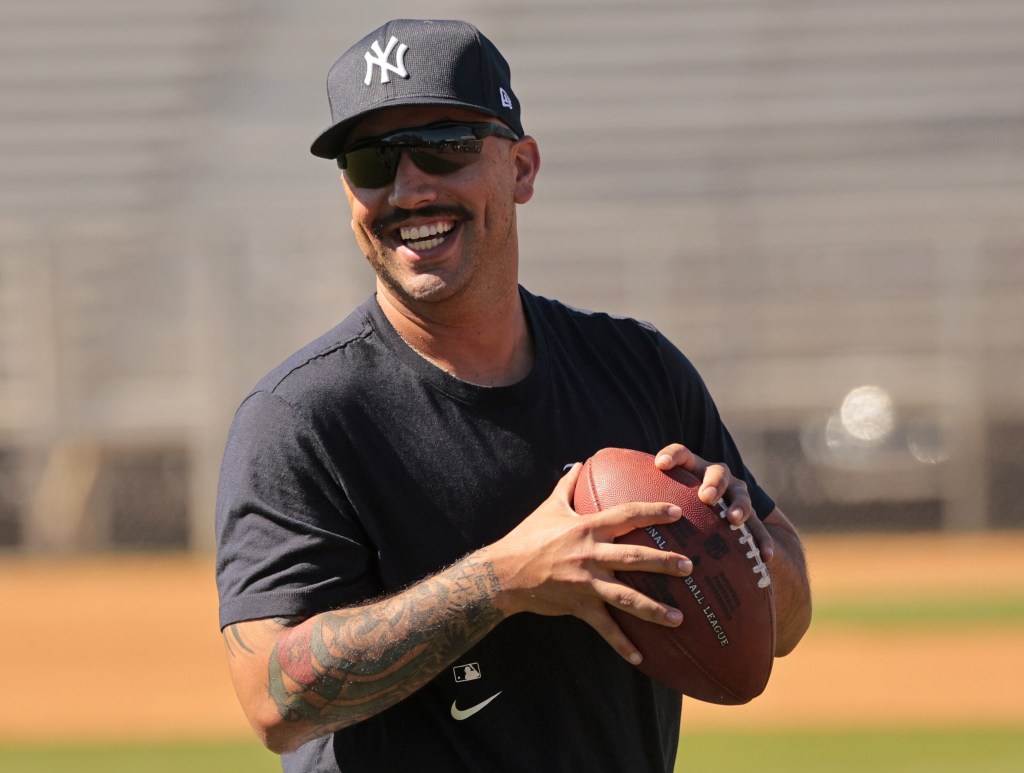 A smiling Nestor Cortes throws a football earlier this week at Yankees' spring training.