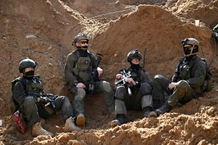 Israeli soldiers operate near a Hamas command tunnel at UNRWA headquarters in Gaza Strip, amidst ongoing conflict.