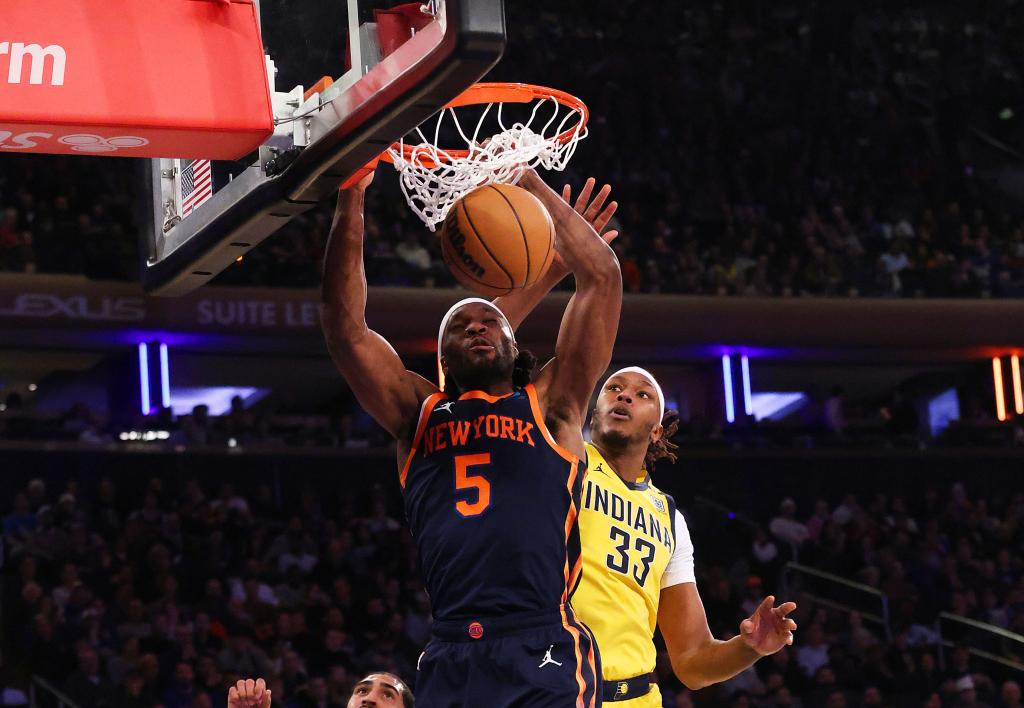 Precious Achiuwa, who had 12 points and 16 rebounds, slams home a dunk during the Knicks' win. 