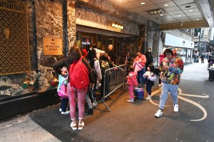 Group of young migrants standing in line outside Roosevelt Hotel, NYC housing migrants on East 45th St. Photo by Helayne Seidman.