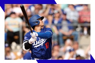 Dodgers star Shohei Ohtani swings at a pitch.