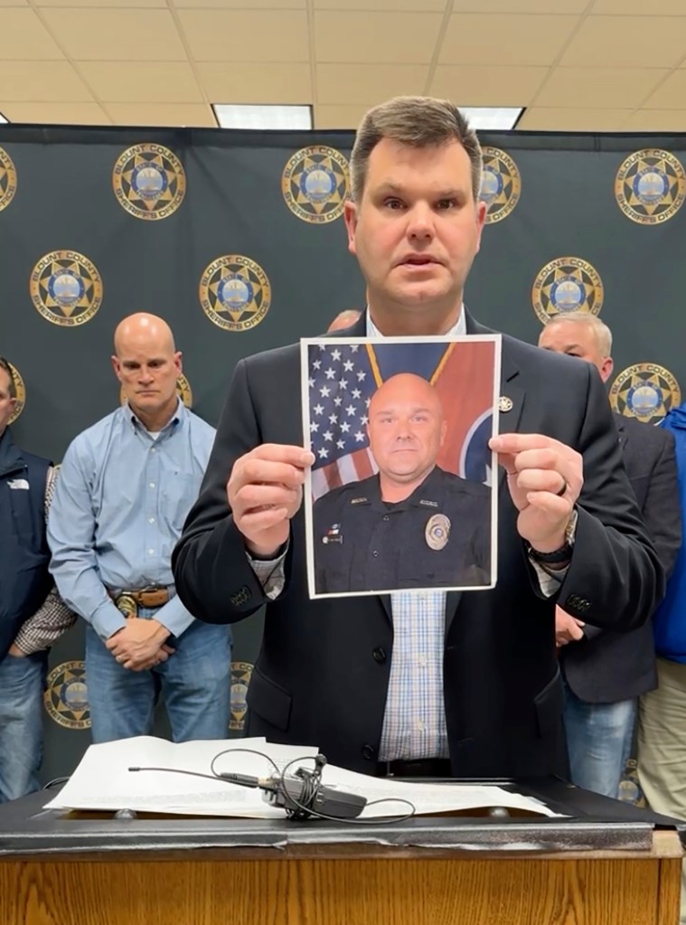 A Blount County Sheriff's official shows a picture of Deputy Greg McCowan, who was shot and killed during a traffic stop in Maryville, Tennessee.