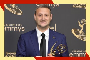 Tim Robinson smiles awkwardly while holding his Emmy.