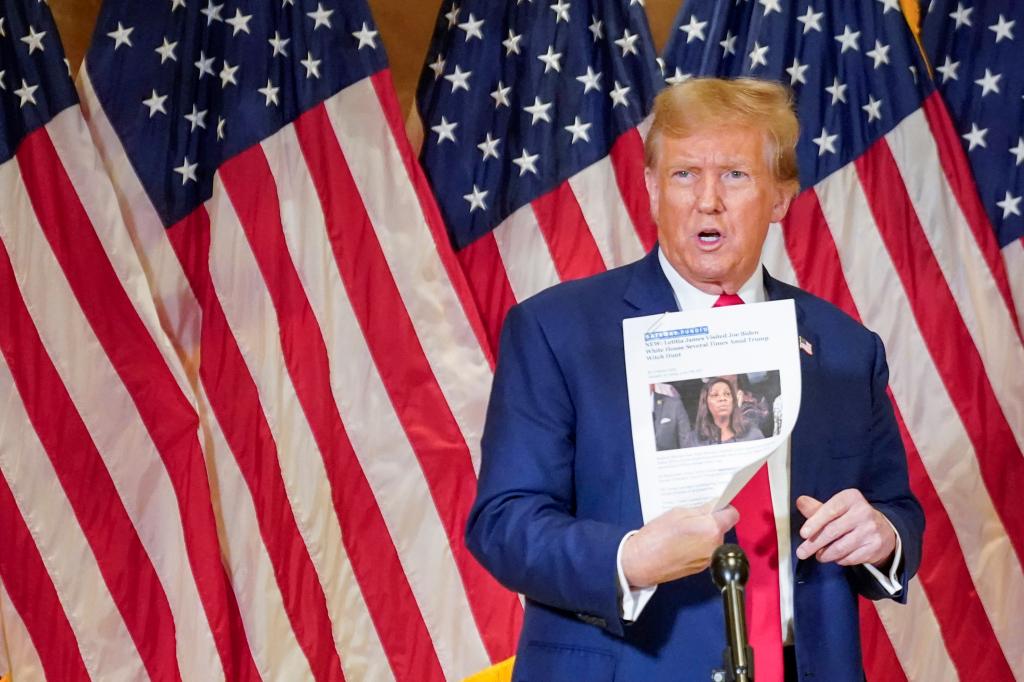 Former President Donald Trump holds up a copy of a story featuring New York Attorney General Letitia James. 