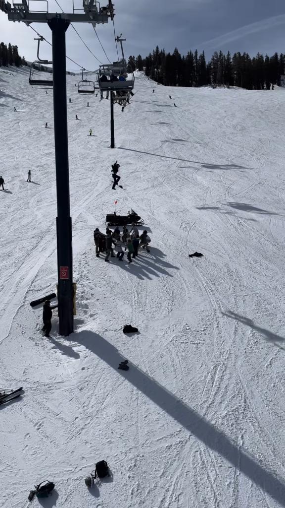 The unidentified teen snowboarder is seen dropping down from the lift toward the ski patrol members.