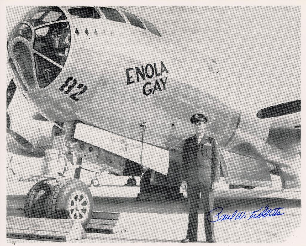 Autographed photo of Paul Tibbets posing in front of the Enola Gay, a B-29 Superfortress heavy bomber. Tibbets was a brigadier general in the U.S. Air Force, and he piloted the Enola Gay during the August 6 drop of the Little Boy weapon over Hiroshima, Japan.