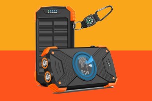 a black and orange portable device with a compass