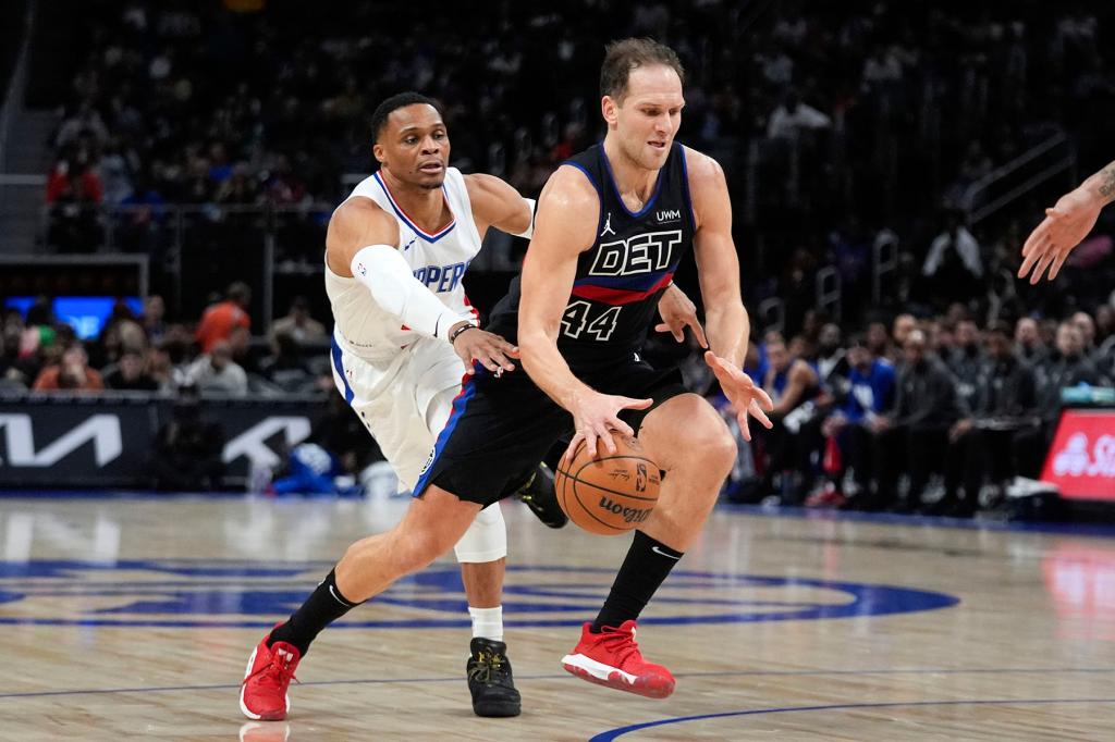 Detroit Pistons forward Bojan Bogdanovic (44) drives on Los Angeles Clippers guard Russell Westbrook (0) in the first half of an NBA basketball game in Detroit, Friday, Feb. 2, 2024. 