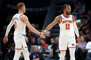 Donte DiVincenzo #0 and Jalen Brunson #11 of the New York Knicks react following a basket during the first half of the game against the Charlotte Hornets.