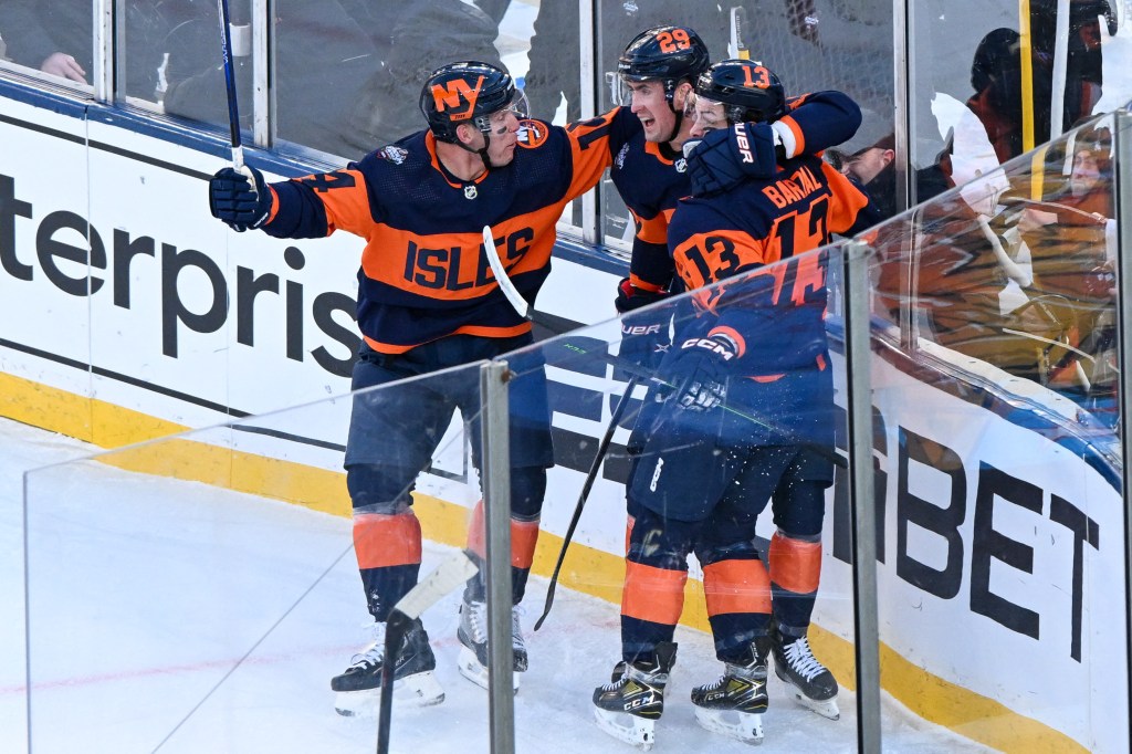 Mathew Barzal celebrates his goal against the Rangers with Brock Nelson (29) and Bo Horvat (14) during the first period in a Stadium Series ice hockey game at MetLife Stadium.