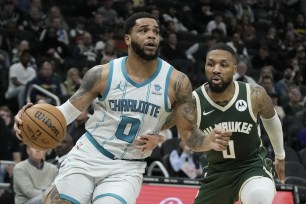 Charlotte Hornets' Miles Bridges gets past Milwaukee Bucks' Damian Lillard during the second half of an NBA basketball game Tuesday, Feb. 27, 2024, in Milwaukee. (AP Photo/Morry Gash)