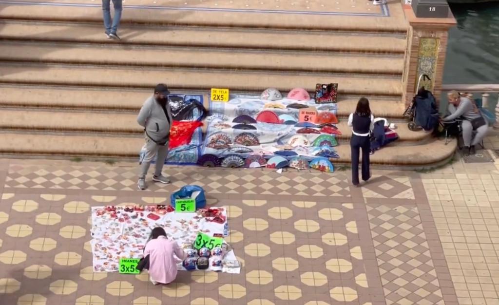 Vendors selling wares on the stairs.