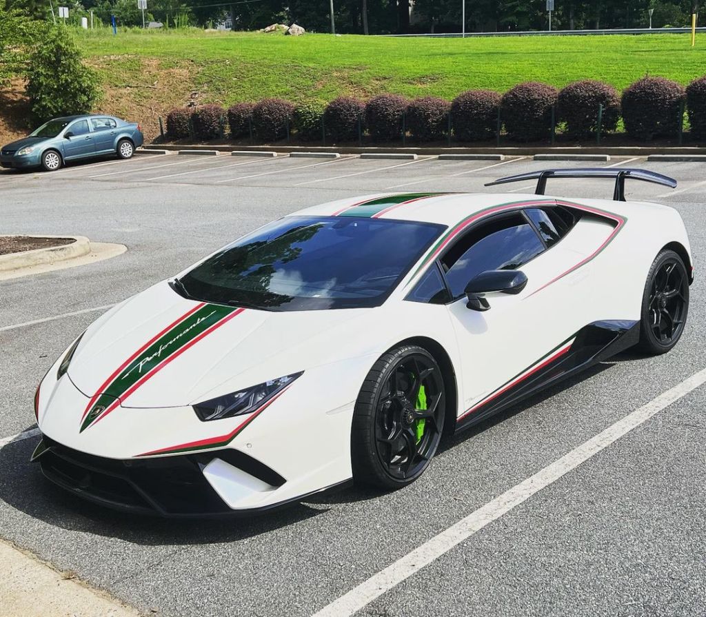 Armstrong's white Lambo in parking lot