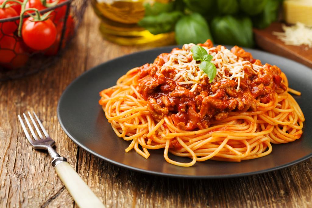 Delicious spaghetti served on a black plate