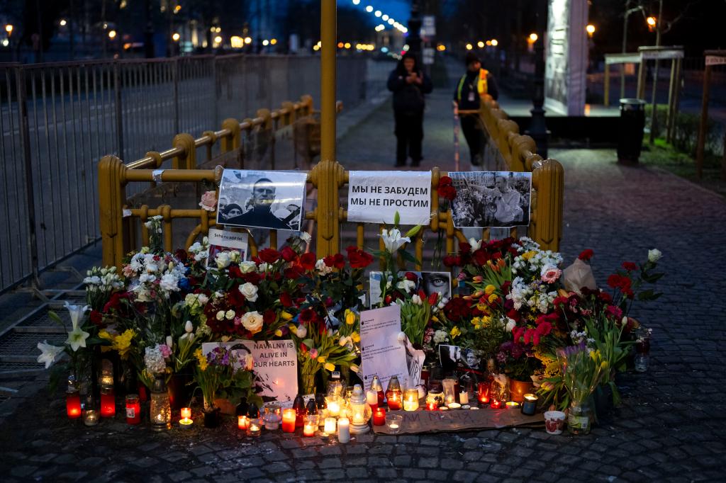 Flower and a pictures are left as a tribute to Russian opposition leader Alexei Navalny, near to the Russian Embassy in Budapest, Hungary, Saturday, Feb. 24, 2024