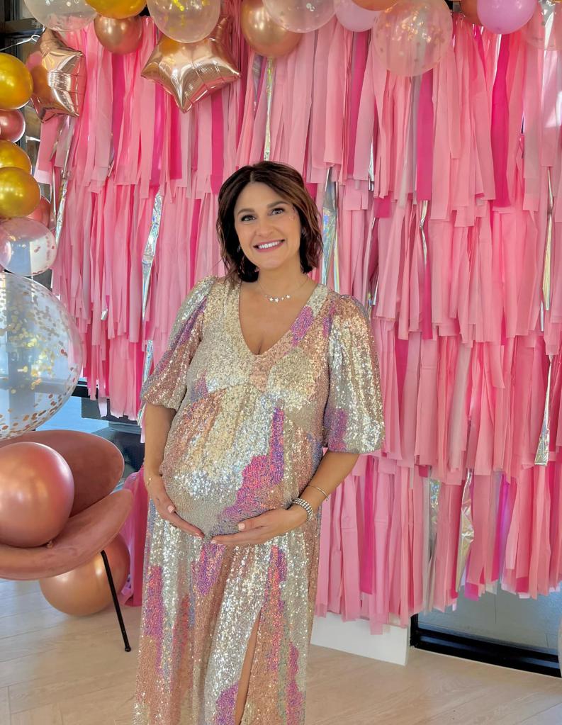 Mother-to-be Shannon Murray wearing a sparkly dress in front of pink decorations and balloons.