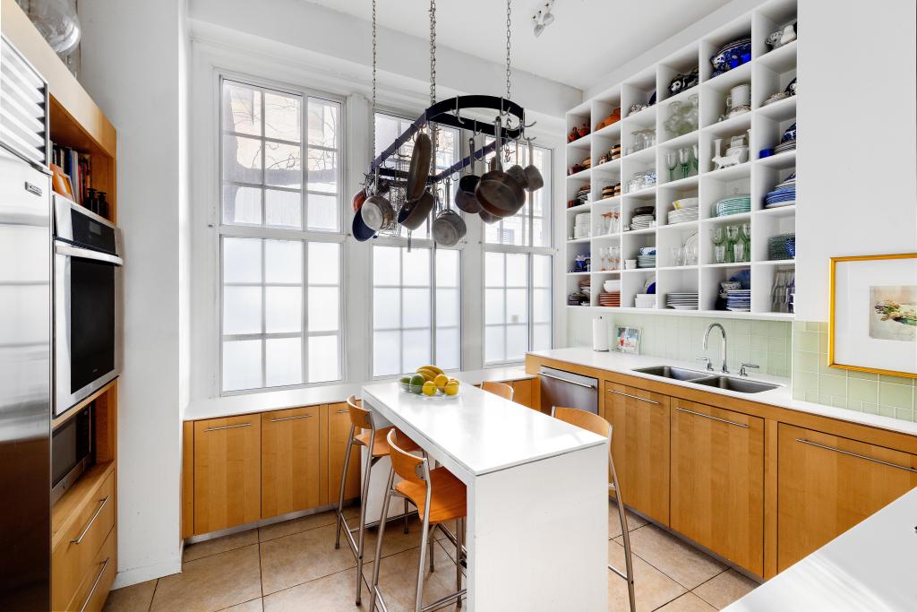 The chef's kitchen has large, paneled windows. 