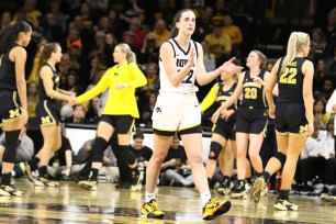  Caitlin Clark #22 of the Iowa Hawkeyes walks off the court after breaking the NCAA women's all-time scoring record