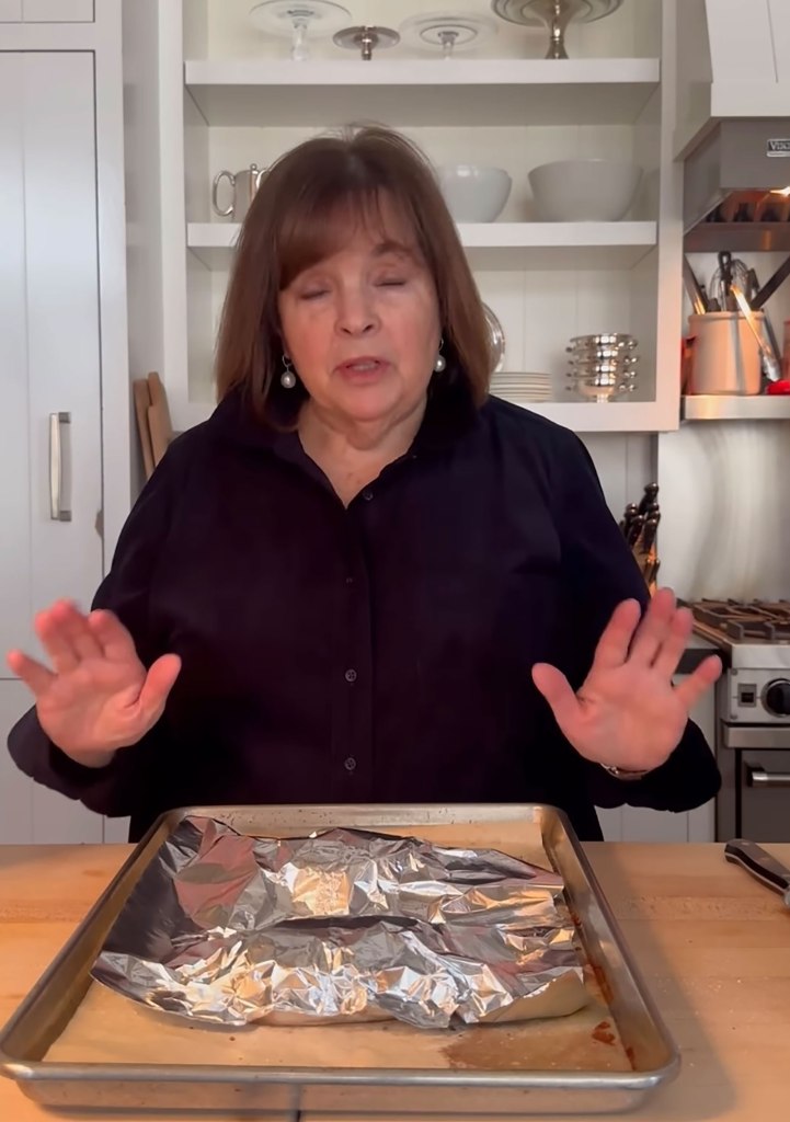 Ina Garten standing next to a baking sheet.