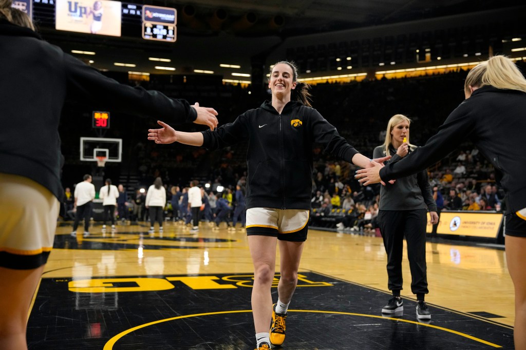 Iowa guard Caitlin Clark warms up for the team's NCAA college basketball game against Michigan.