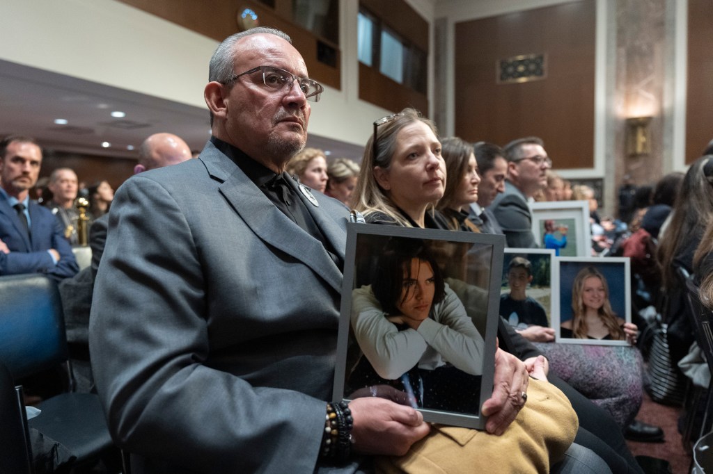 Jaime Puerta, of Santa Clarita, Calif., holds a picture of his son Daniel Joseph Puerta-Johnson