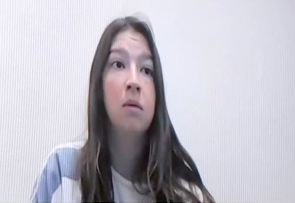 Komoroski stares blankly during a video call with a loved one while in jail awaiting trial.