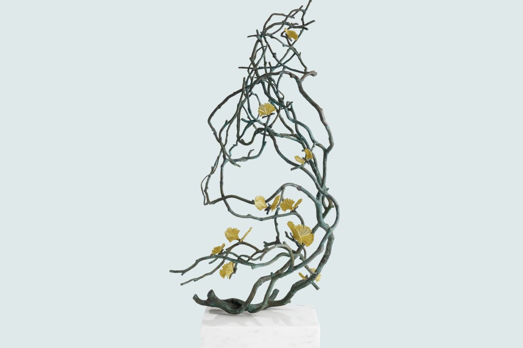 a sculpture of a tree branch with leaves