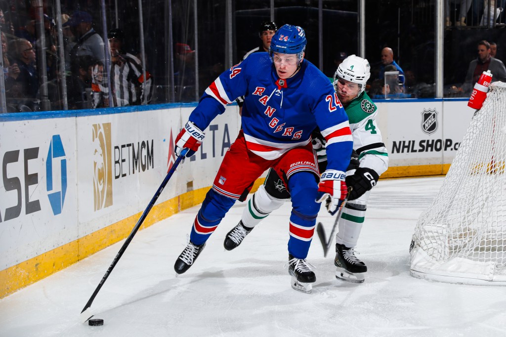 Kaapo Kakko skates the puck around the nets for the Rangers.