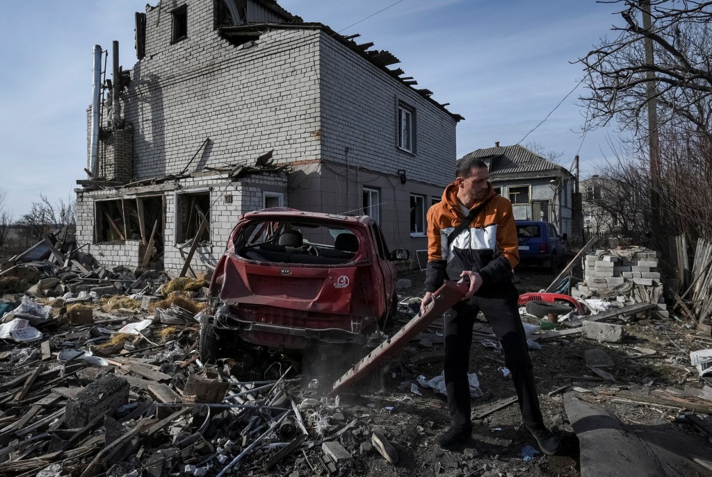 A man checks his car destroyed by a Russian drone strike in Dnipro, Ukraine, on Monday. 