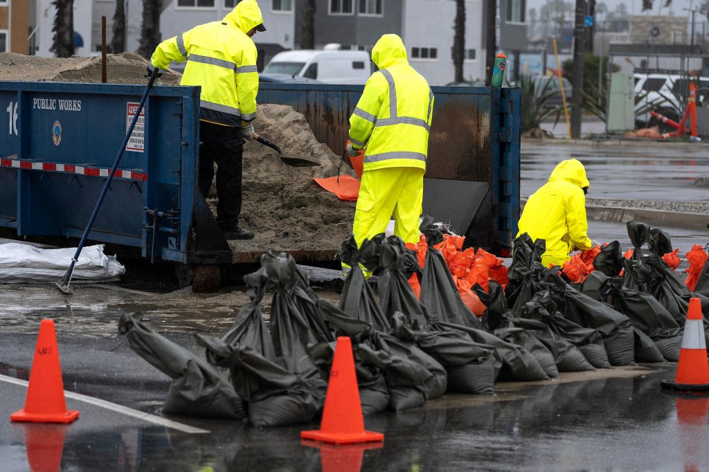 Long Beach Fire Department Oceanside lifeguards filling sandbags to protect homes during the storm on Feb. 19, 2024.