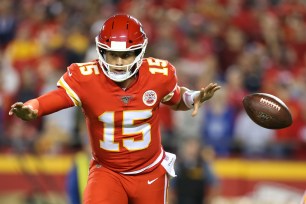 Kansas City Chiefs quarterback Patrick Mahomes (15) looks away as he tosses the ball on a reverse in the second quarter of an NFL matchup between the Indianapolis Colts and Kansas City Chiefs on October 6, 2019 at Arrowhead Stadium in Kansas City, MO.