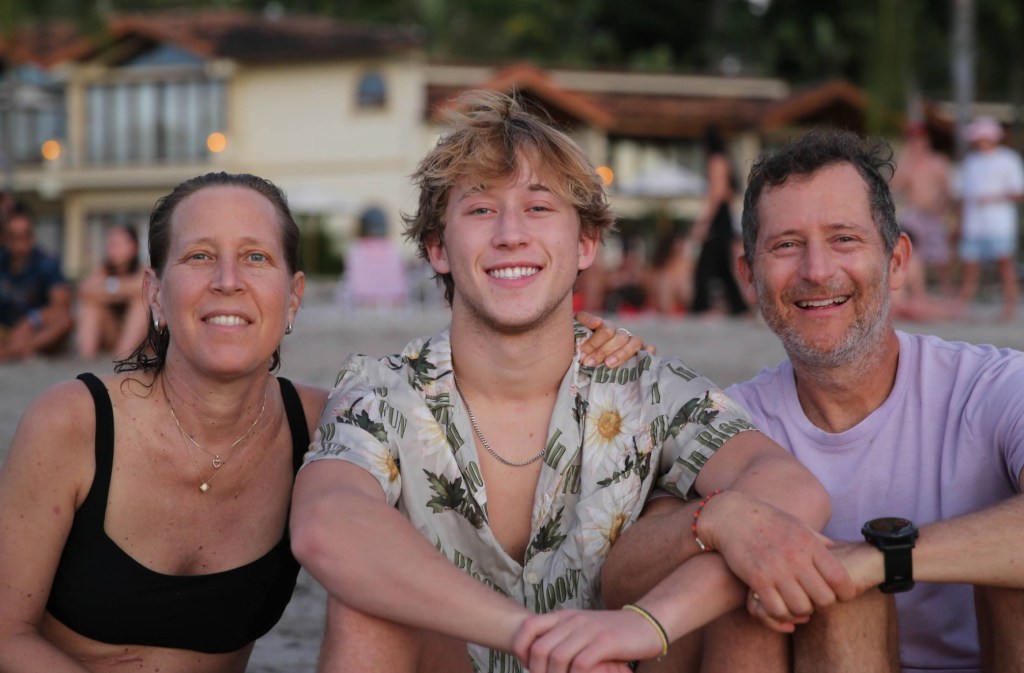 Marco Troper seen with his parents on the beach