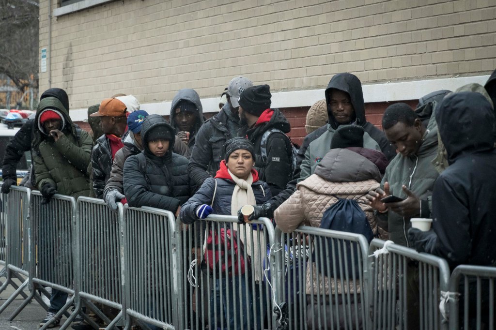 People standing in line at immigrant intake center at St Brigid school in East Village, Manhattan NY (photo by Stefano Giovannini).