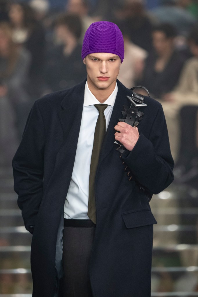 A model in a purple hat and tie