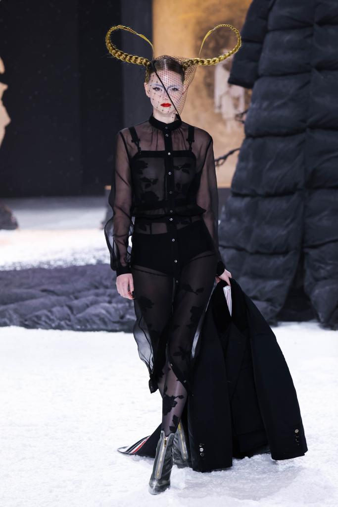 Model walks runway wearing black dress at Thom Browne Fall 2024 show during New York Fashion Week in February 2024.