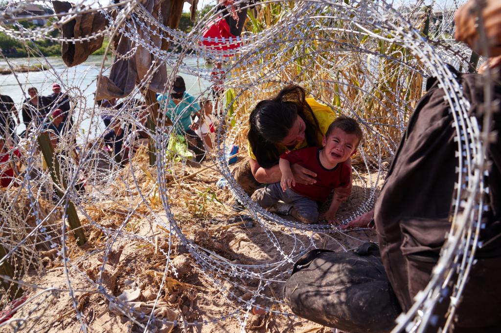 A mother from Honduras crawled through concertina wire with her three children after crossing the Rio Grande river from Mexico into the United States on Sunday, September 24, 2023