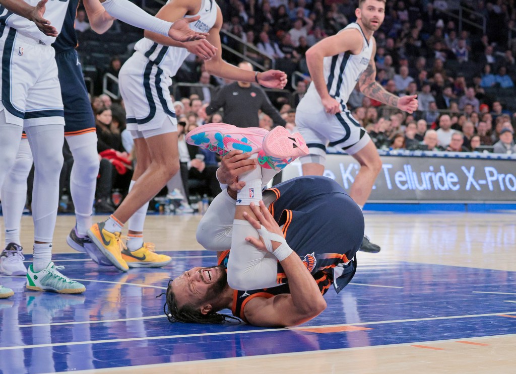 Jalen Brunson hold his injured ankle late in the Knicks's win over the Grizzlies on Monday. 