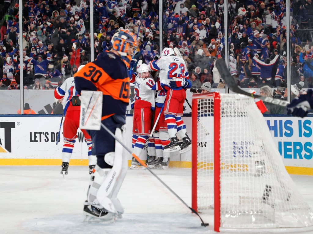 Rangers' Adam Fox jumps onto his teammates as they celebrate New York Rangers center Mika Zibanejad goal during the third period on Sunday.