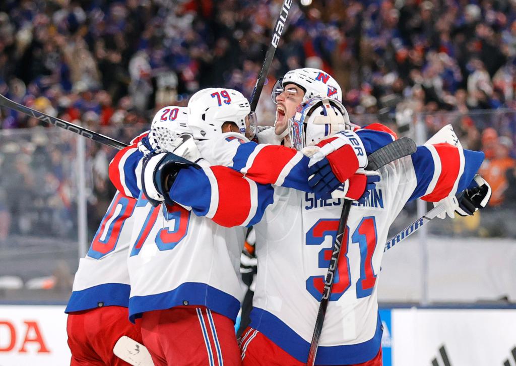 The Rangers celebrate their 6-5 overtime win over the Islanders at MetLife Stadium on Sunday.