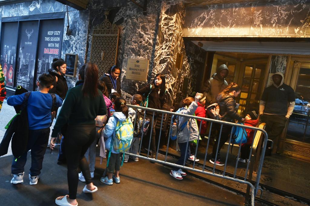 Migrants outside of the shelter at the Roosevelt Hotel on Feb. 9, 2024.