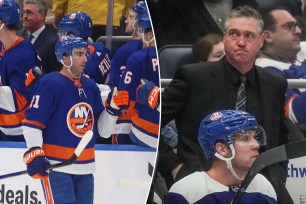 Kyle Palmieri gets fist bumps from the Islanders bench; head coach Patrick Roy looks on