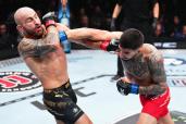 Ilia Topuria (right) punches Alexander Volkanovski during his victory in their UFC featherweight title bout.