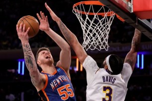 Isaiah Hartenstein, who scored six points and grabs 15 rebounds, looks to shoot over Anthony Davis during the Knicks' 113-105 win over the Lakers.