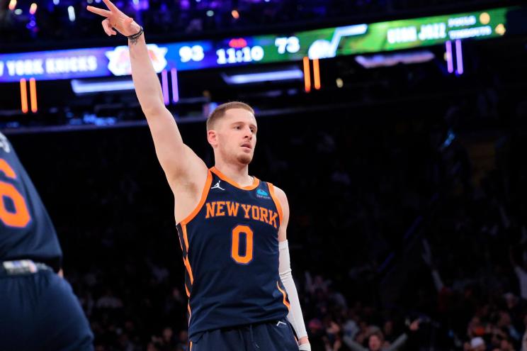 The Knicks' Donte DiVincenzo follows through after making a shot.